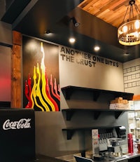 a coca cola restaurant with a fireplace on the wall